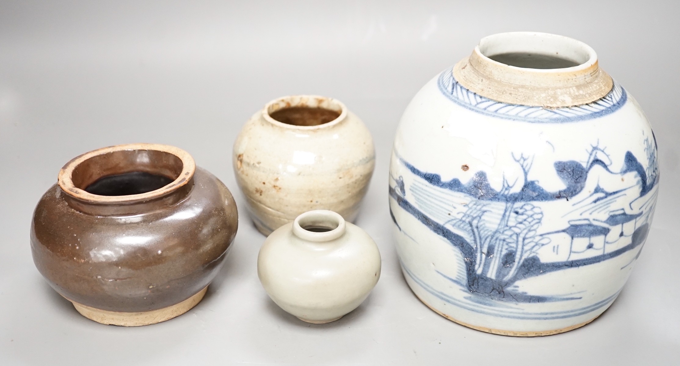 A Chinese celadon jarlet, Yuan-Ming Dynasty, two provincial stoneware jars and a 19th century Chinese provincial blue and white jar, tallest 16cm